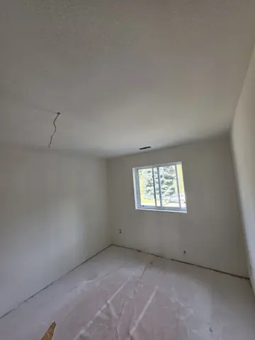 Bedroom with finished drywall and orange-peel texture