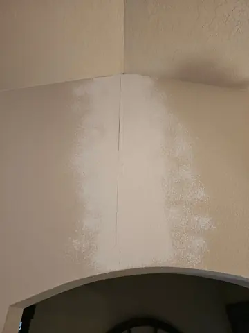 Reopened crack above an arched doorway
