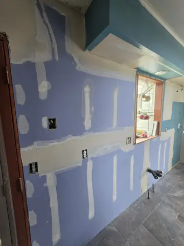 Kitchen moisture-resistant drywall installed and taped