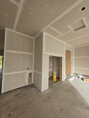 Garage utility enclosure with installed and fire-taped drywall