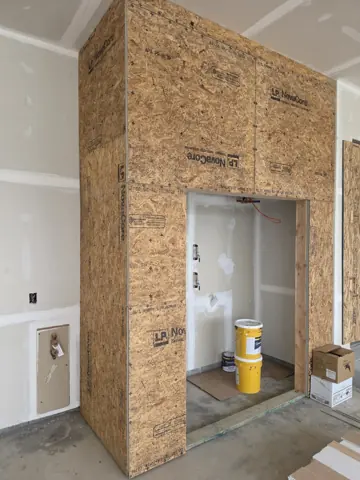 Framed garage utility enclosure before drywall